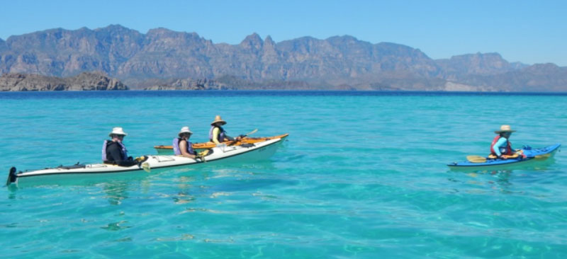Kayaks floating on clear blue water