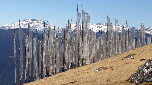 Prayer flags with snowy peaks